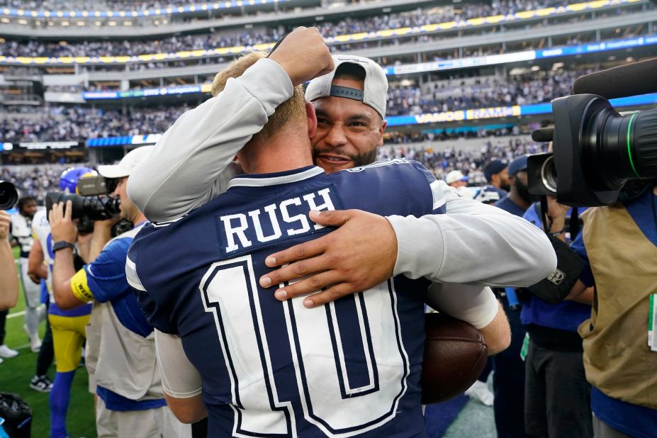 Dallas Cowboys quarterback Cooper Rush celebrates with Dak Prescott after the team's 22-10 win against the Los Angeles Rams. Rush stepped in for starting quarterback Prescott in Week 2 after Prescott suffered a hand injury. Since then, the Cowboys have won four straight games. 
