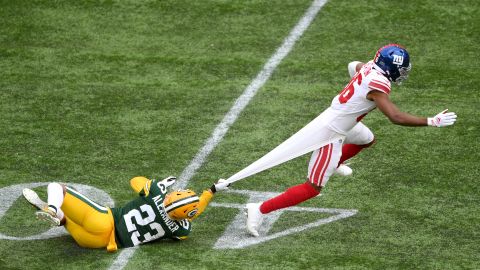 Gaints receiver Darius Slayton has his jersey pulled by the Packers' Jaire Alexander as he attempts to be tackled.