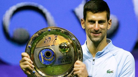 Serbia's Novak Djokovic celebrates with the trophy after defeating Greece's Stefanos Tsitsipas in their men's singles final match at the Astana Open tennis tournament in Astana on October 9, 2022. 