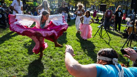Chali'Naru Dones, with the United Confederation of Taino People, dances in the Christopher Columbus Waterfront Park during an Indigenous Peoples' Day rally and march in Boston on October 10, 2020. 