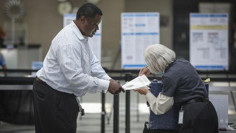 A voter in Denver turns in his ballot for the Colorado primary elections on June 28, 2022.