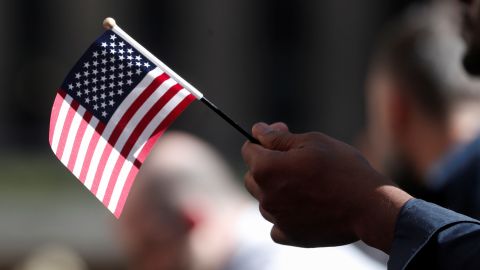A citizenship candidate holds a flag during a naturalization ceremony in New York City on September 17, 2019.