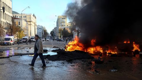 Cars burn after a Russian military strike in Kyiv.