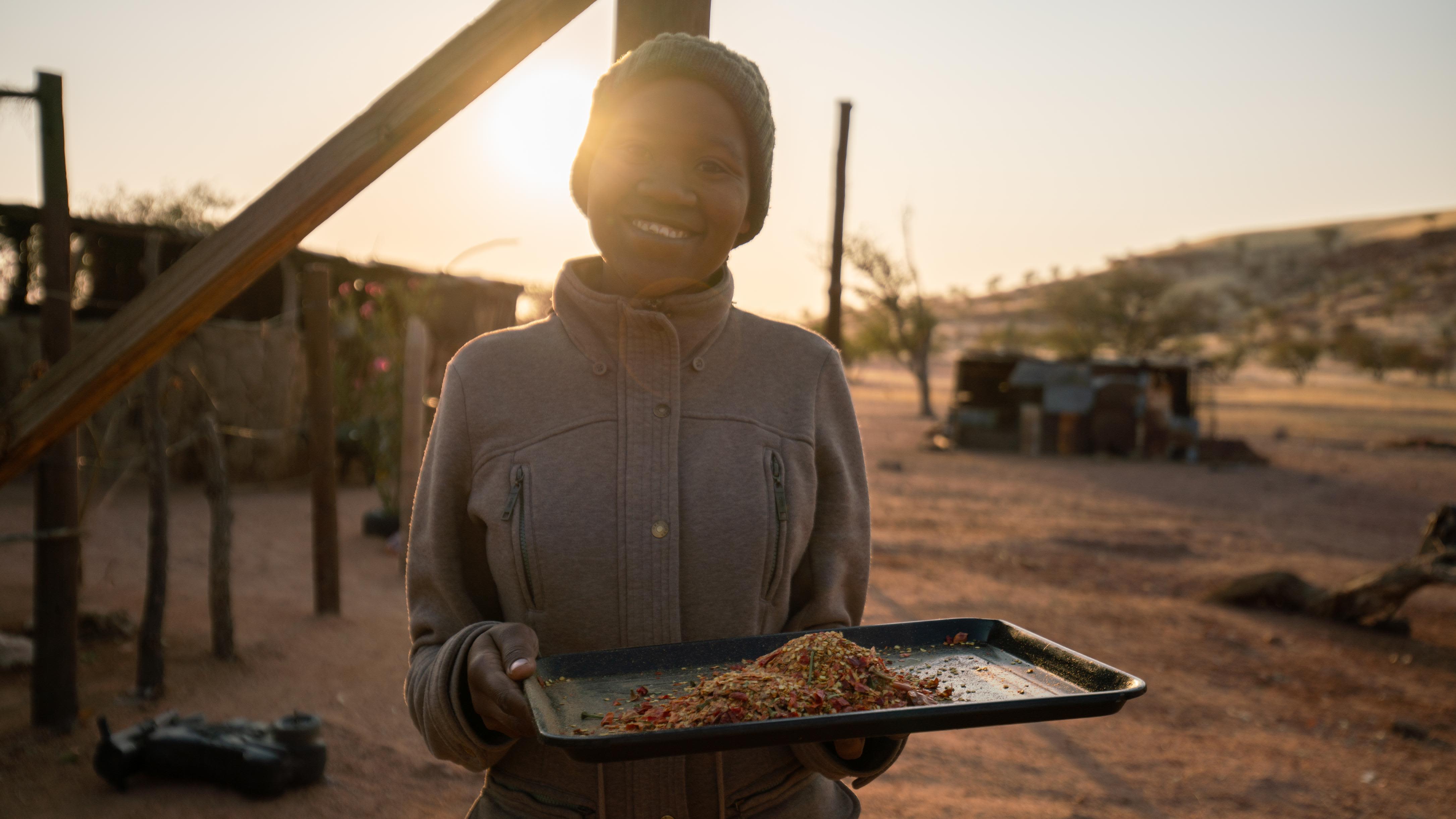 Sometimes, the elephants venture into the community, usually looking for a vegetable garden. This woman carries chilies, which are used to deter elephants.