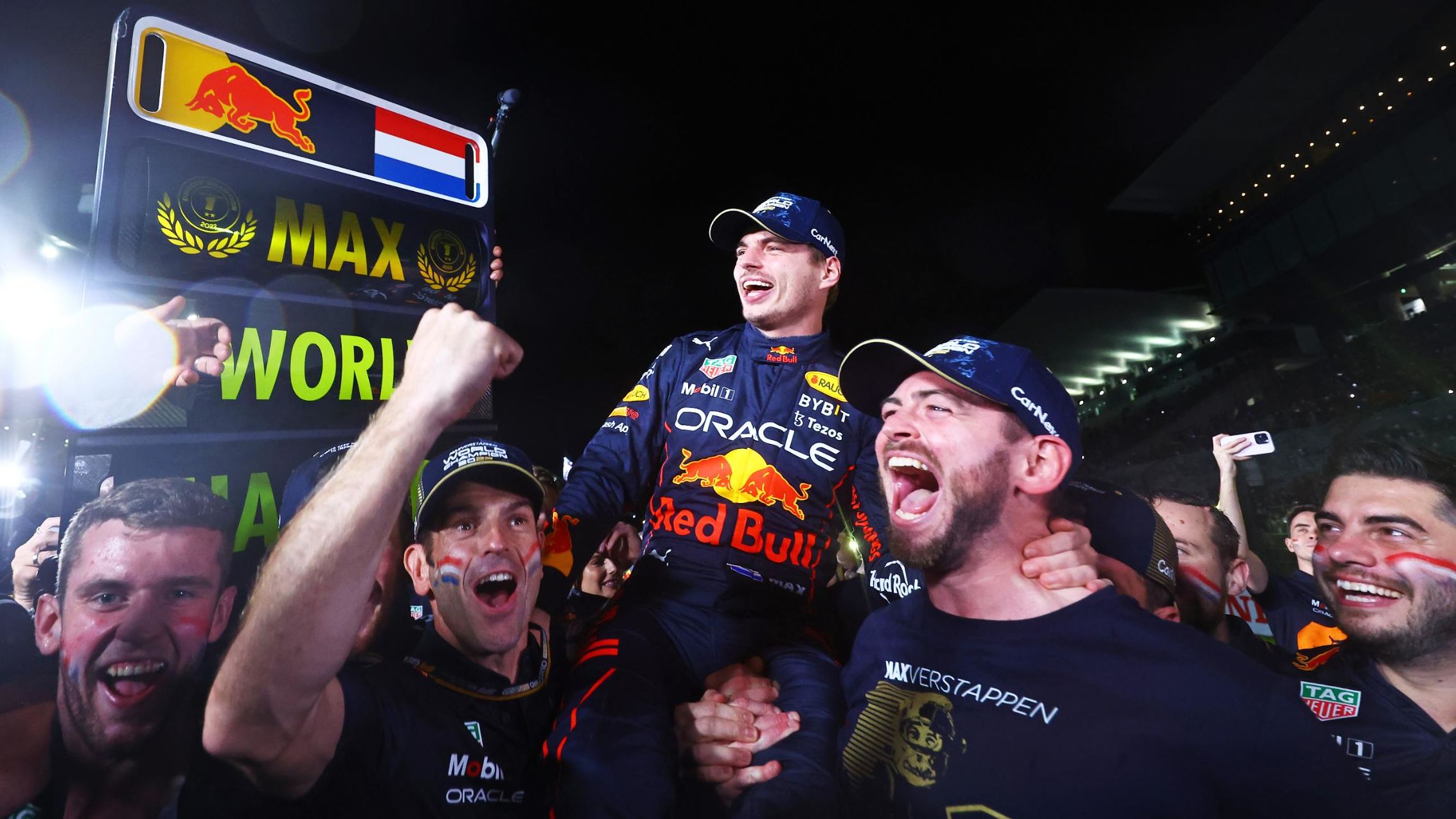 Max Verstappen is held aloft as his Red Bull team celebrates winning the drivers' championship.