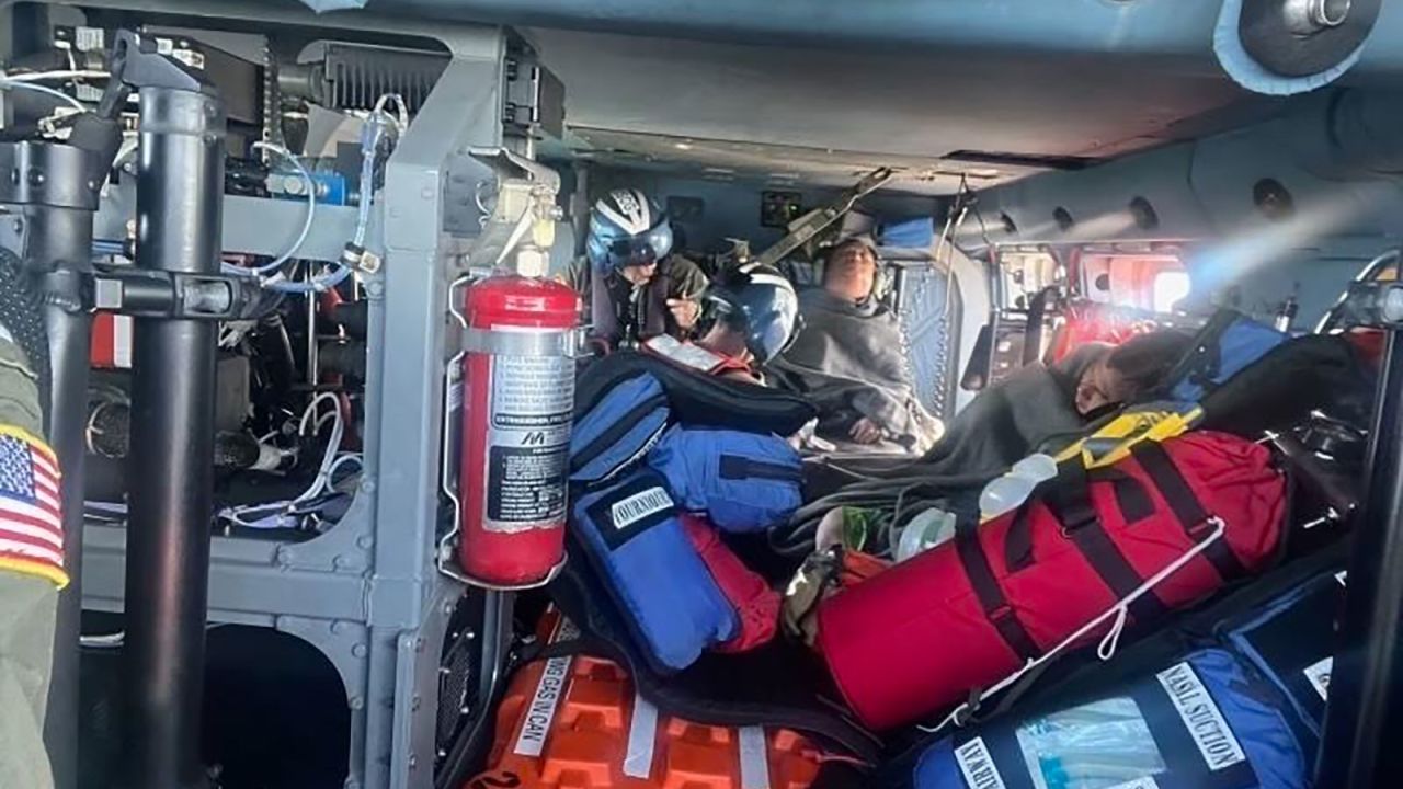 A Coast Guard Air Station New Orleans MH-60 Jayhawk aircrew treats three rescued boaters for injuries Sunday.