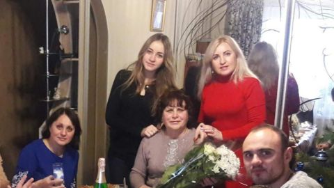 Liubov Petrova (centre) with her family at their home on Pershotravneva Street 2 in 2018. 