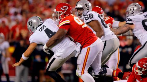 Carr is tackled by Jones after which a roughing-the-passer penalty call was called. 