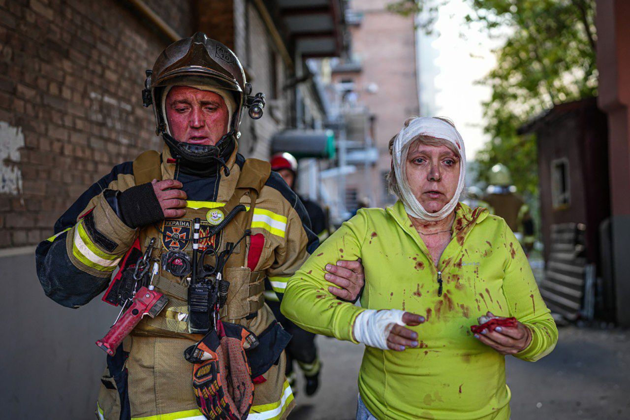 A fireman helps an injured civilian after several explosions hit the Shevchenkivskyi district of the Ukrainian capital, Kyiv, on October 10.  Zelensky says Russia waging war so Putin can stay in power &#8216;until the end of his life&#8217; 221011104750 02 ukraine gallery update