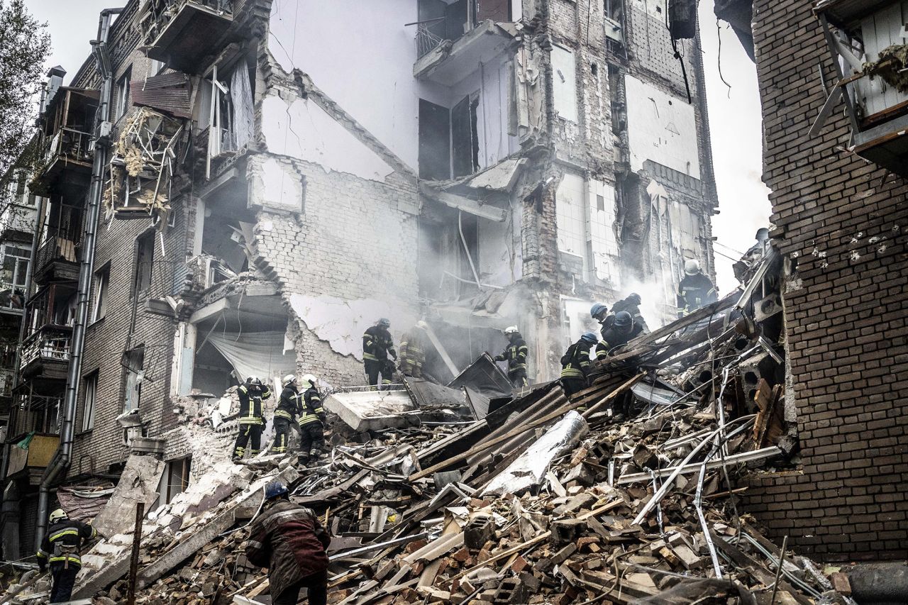 Firefighters conduct work on a damaged building after a Russian missile attack in Zaporizhzhia, Ukraine, on October 10.  Zelensky says Russia waging war so Putin can stay in power &#8216;until the end of his life&#8217; 221011104829 03 ukraine gallery update