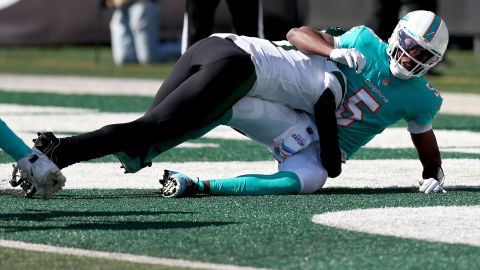 Bridgewater is tackled by Sauce Gardner of the New York Jets.