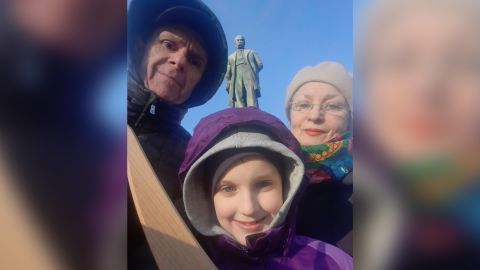 The writer's son, Askold, holds his wooden sword alongside grandparents Roman Weretelnyk and Halyna Stefanova in Shevchenko Park earlier this year. The statue of poet Taras Shevchenko can be seen in the background.