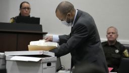Darrell Brooks looks through some files during the Darrell Brooks trial in a Waukesha County Circuit Court in Waukesha, Wis., on Monday, Oct. 10, 2022. Brooks, who is representing himself during the trial, is charged with driving into the Waukesha Christmas Parade last year, killing six people and injuring dozens more. (Mike De Sisti/Milwaukee Journal-Sentinel via AP, Pool)