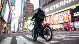 A food delivery man crosses the street in Times Square in Manhattan on March 17, 2020 in New York City.