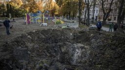 KYIV, UKRAINE - OCTOBER 11: People look at the crater left by a missile strike on a playground in Taras Shevchenko Park the day before on October 11, 2022 in Kyiv, Ukraine. Ukraine's emergency services said that 19 people were killed across the country yesterday in a widespread Russian attack on major cities, including the capital. (Photo by Ed Ram/Getty Images)
