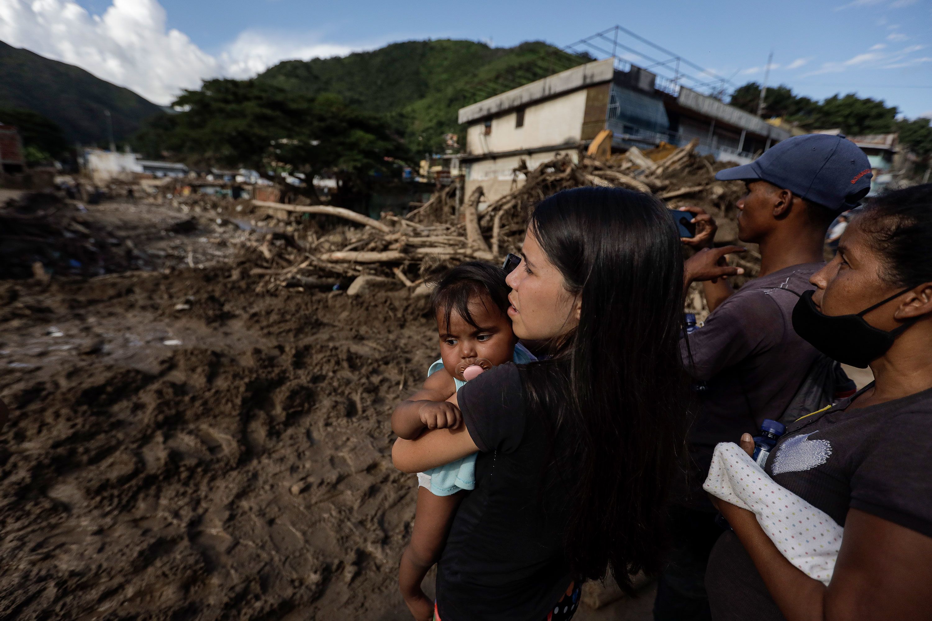 A woman looks at damage in Las Tejerias on Monday, October 10.