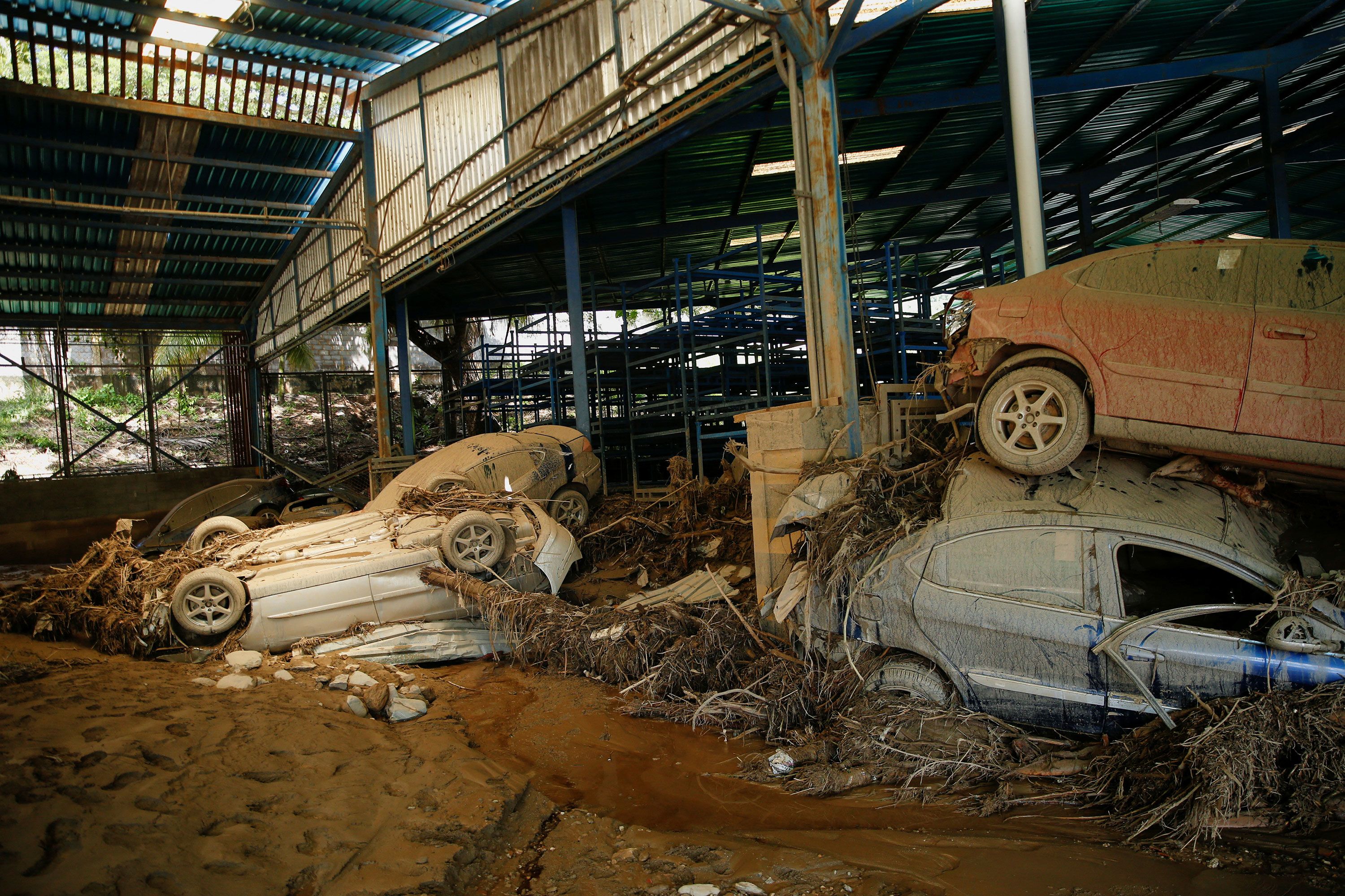 Damaged vehicles sit at a car assembly plant on Monday.