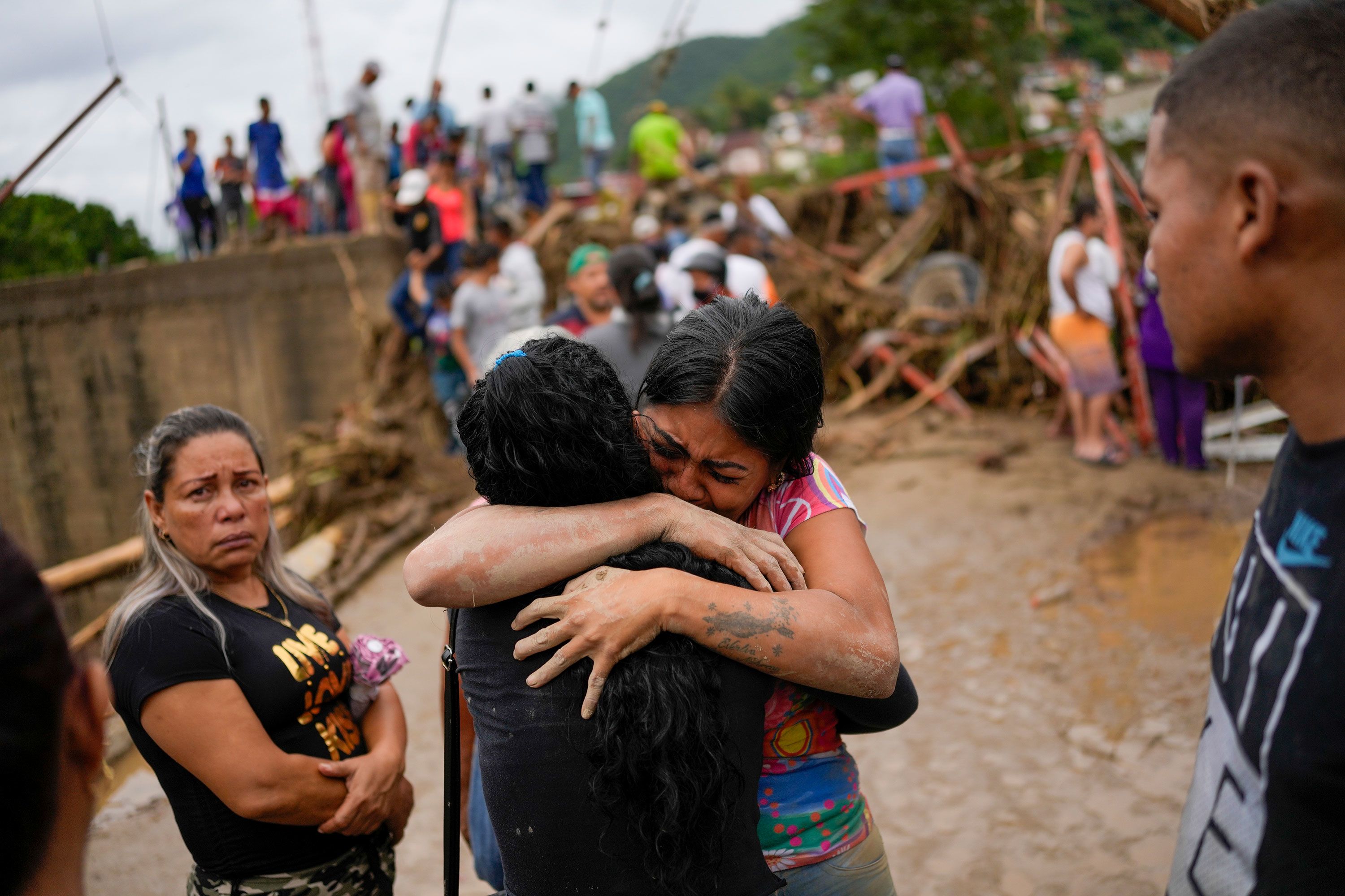 Residents embrace in Las Tejerias on Sunday.