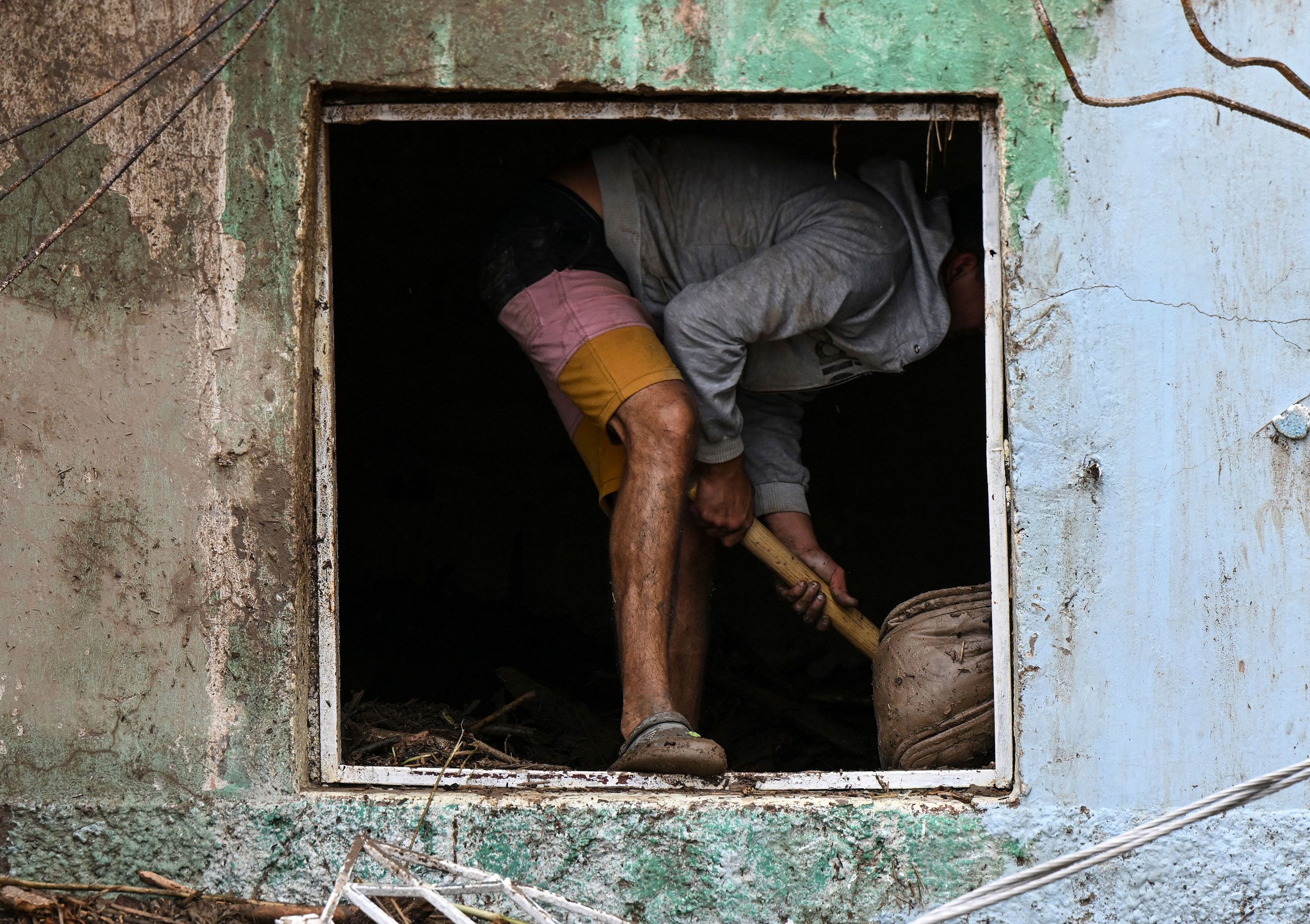 A resident searches for his missing relatives in the rubble of a house on Sunday.