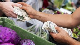 A vendor makes change at the 79th St. Greenmarket on the Upper West Side of Manhattan, on Sunday, August 21, 2022. 
