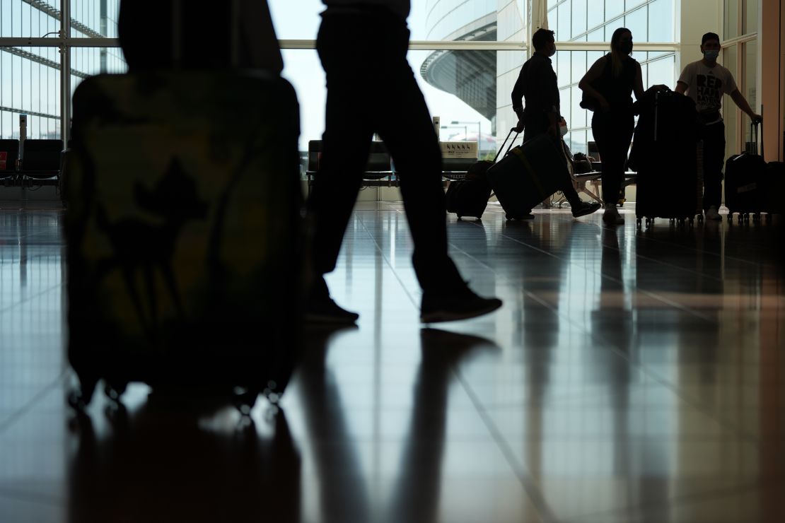 Passenger walk through the arrival lobby of Haneda Airport in Tokyo on Oct. 11. Japan began accepting vaccinated visitors from 68 countries without visas Tuesday, ending almost three years of tighter border controls.