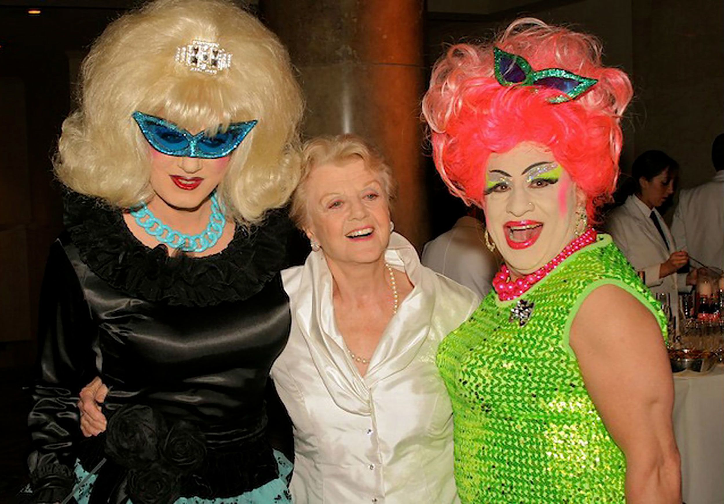 Lansbury poses with drag queens Brandy Wine and Brenda A. Go-Go during a costume ball in New York in 2006.