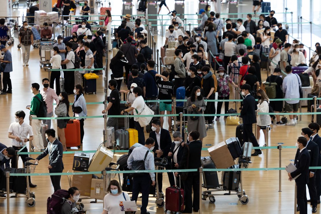 Travelers wait in line at the Vietnam Airlines JSC counter at South Korea's Incheon International Airport on September 8, 2022. 