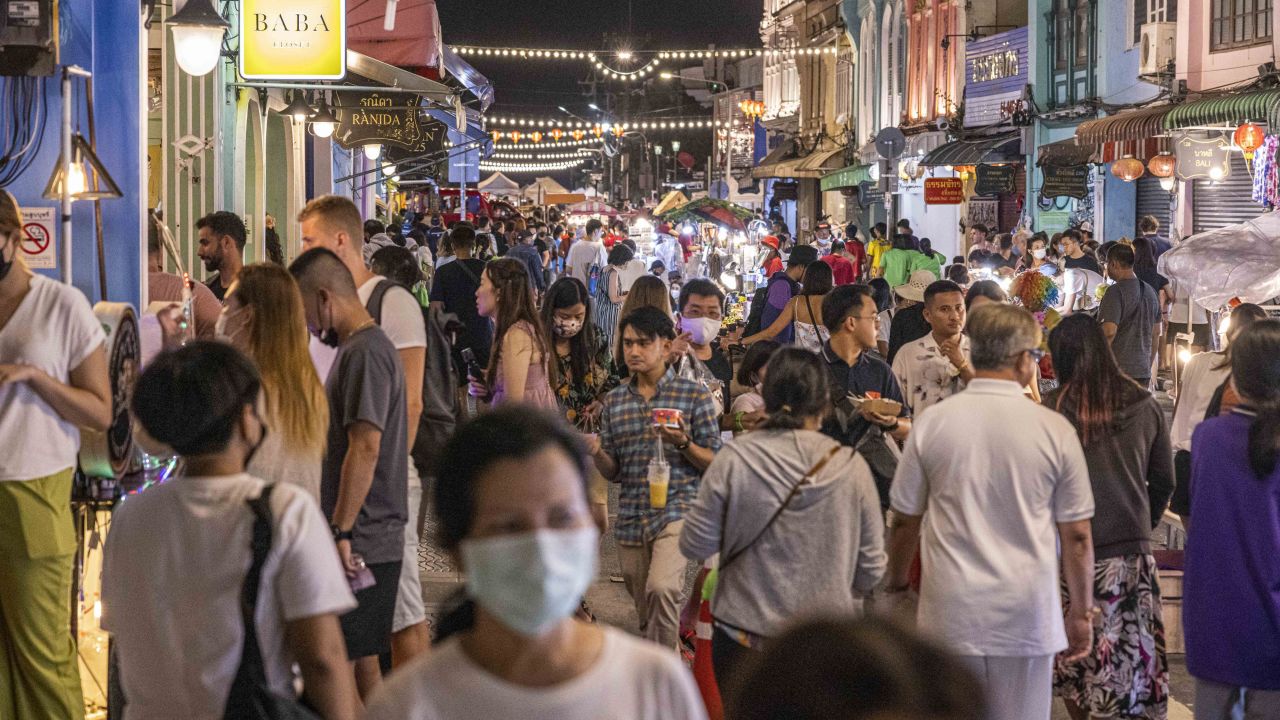 Tourists and locals browse a street market in Phuket, Thailand, on October 2.