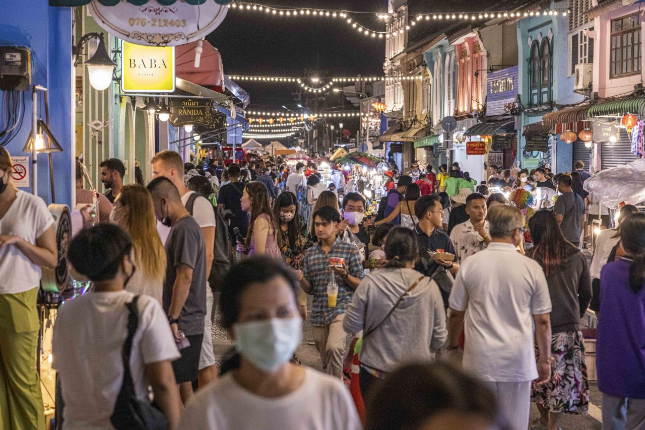 Tourists and locals browse a street market in Phuket, Thailand, on October 2.
