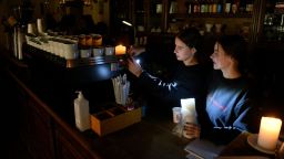 Employees prepare coffee in a cafe without electricity in western Ukrainian city of Lviv,  after three Russian missiles fired targeted energy infrastructure on October 11, 2022. - In Lviv, the largest city in the region of the same name, the mayor said on October 11, 2022 that one-third of homes were without power. (Photo by Yuriy Dyachyshyn / AFP) (Photo by YURIY DYACHYSHYN/AFP via Getty Images)