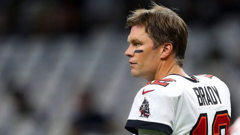 Brady takes off his helmet and looks toward the sidelines during the Tampa Bay Buccaneers game against New Orleans Saints on September 18, 2022.