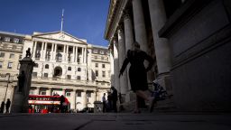 People walk past the Bank of England in London, Britain, 11 October 2022. 