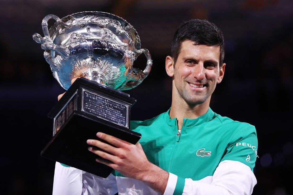 Djokovic holds the Norman Brookes Challenge Cup as he celebrates victory at the 2021 Australian Open.
