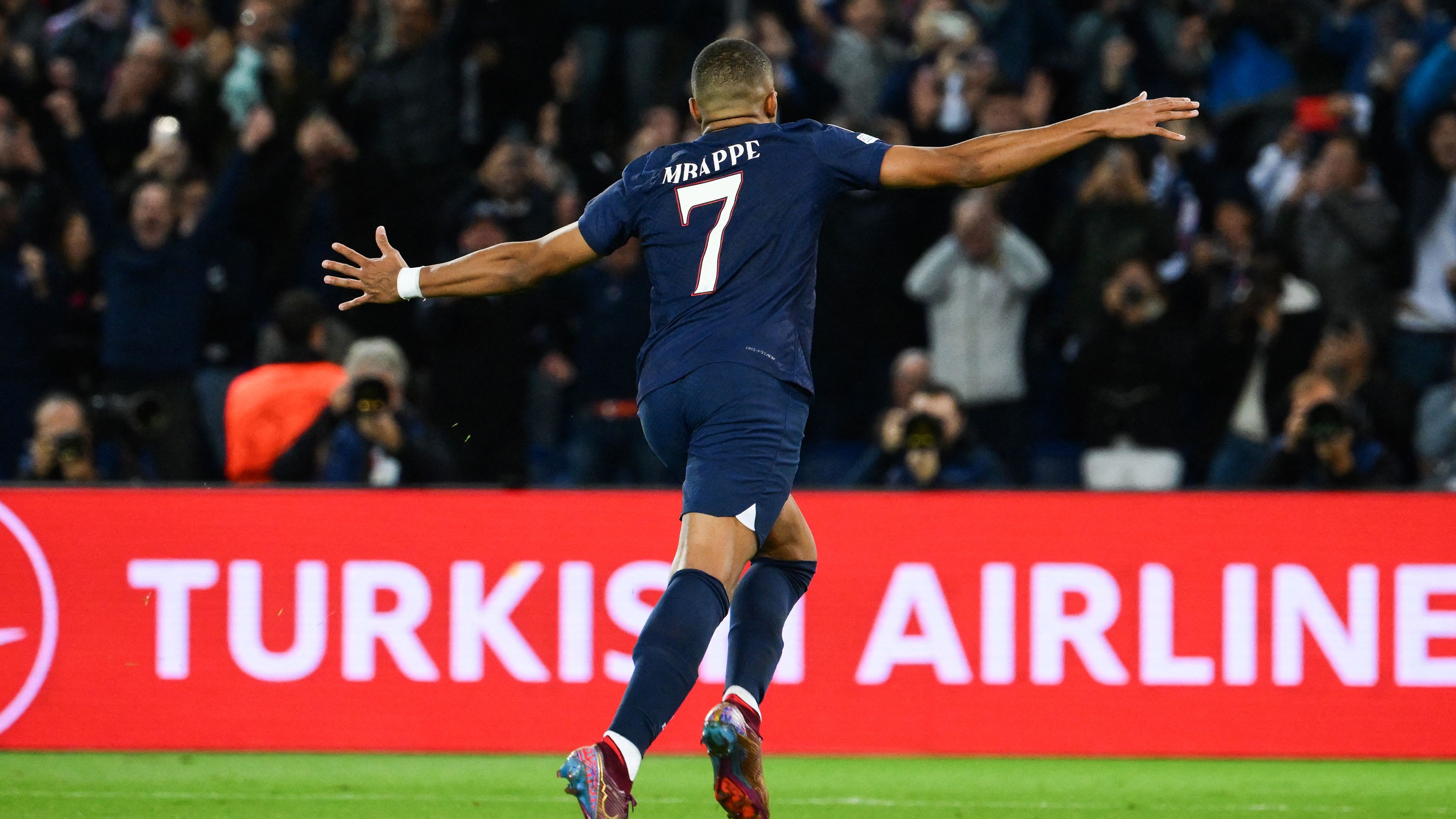 Mbappe celebrates scoring his penalty against Benfica.