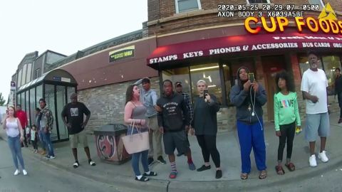 In this image from a police body camera, bystanders, including Darnella Frazier, filming, third from right, witness then-Minneapolis police officer Derek Chauvin pressing his knee on George Floyd's neck for several minutes, killing him on May 25, 2020, in Minneapolis.