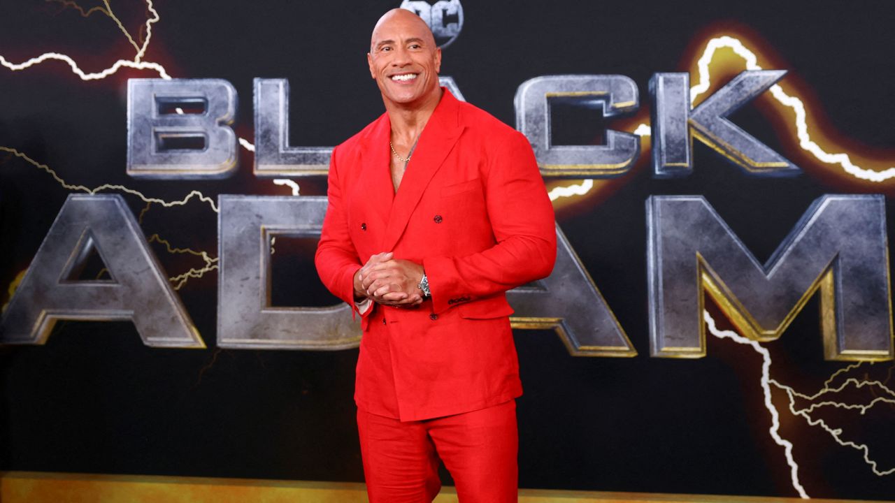Dwayne Johnson poses for photographers as he arrives for the world premiere of the film 'Black Adam' in New York on Wednesday.