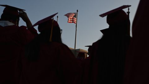 A US flag flies above a building as students earning degrees at Pasadena City College participate in the graduation ceremony, June 14, 2019, in Pasadena, California.