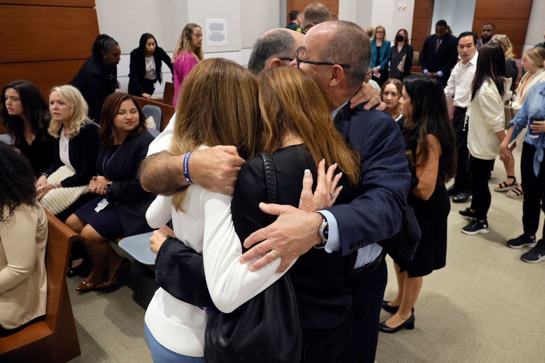 Linda Beigel Schulman, Michael Schulman, Patricia Padauy Oliver and Fred Guttenberg, families of the victims, embrace in the courtroom before the verdict is read.