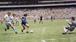 TOPSHOT - Argentinian forward Diego Armando Maradona (3rd L) runs past English defender Terry Butcher (L) on his way to dribbling goalkeeper Peter Shilton (R) and scoring his second goal, or goal of the century, during the World Cup quarterfinal soccer match between Argentina and England on June 22, 1986 in Mexico City. Argentina advanced to the semifinals with a 2-1 victory. (Photo by STAFF / AFP) (Photo by STAFF/AFP via Getty Images)