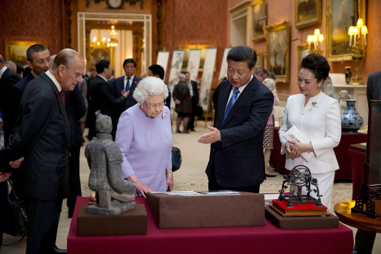 Xi and Peng meet with Britain's Queen Elizabeth II and her husband, Prince Philip, during a trip to London's Buckingham Palace in 2015.