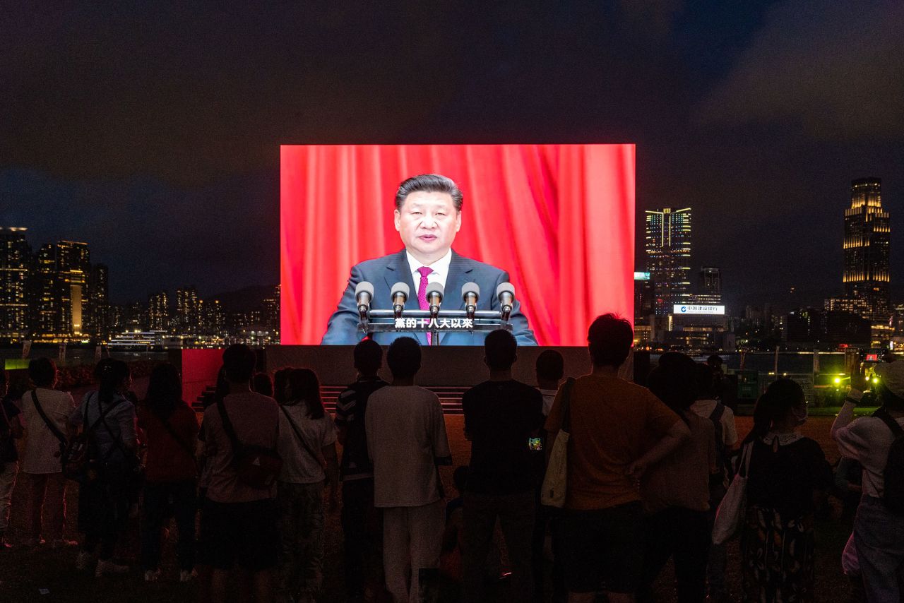 A screen shows Xi speaking at a light show in Hong Kong in July 2021.