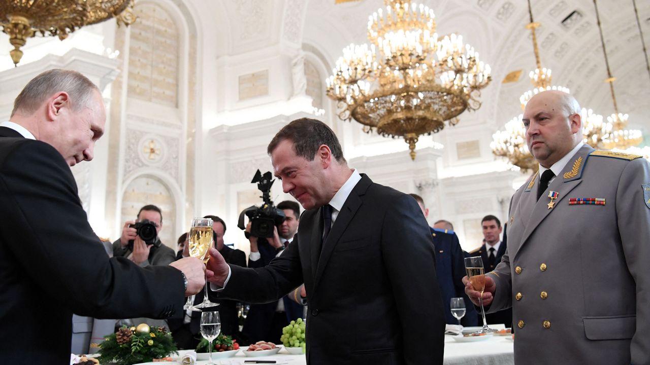 Vladimir Putin (left) toasts with then-Prime Minister Dmitry Medvedev next to Sergey Surovikin after a ceremony to bestow state awards on military personnel who fought in Syria, on December 28, 2017.