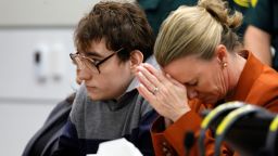 Assistant Public Defender Melisa McNeill, seated with Marjory Stoneman Douglas High School shooter Nikolas Cruz touches her hands to her head as the last of the 17 verdicts were read in the penalty phase of Cruz's trial at the Broward County Courthouse in Fort Lauderdale, Fla., on Thursday, Oct. 13, 2022.  Cruz will be sentenced to life without parole for the 2018 massacre of 17 people at Parkland's Marjory Stoneman Douglas High School. That sentence comes after the jury announced Thursday that it could not unanimously agree that Cruz should be executed.