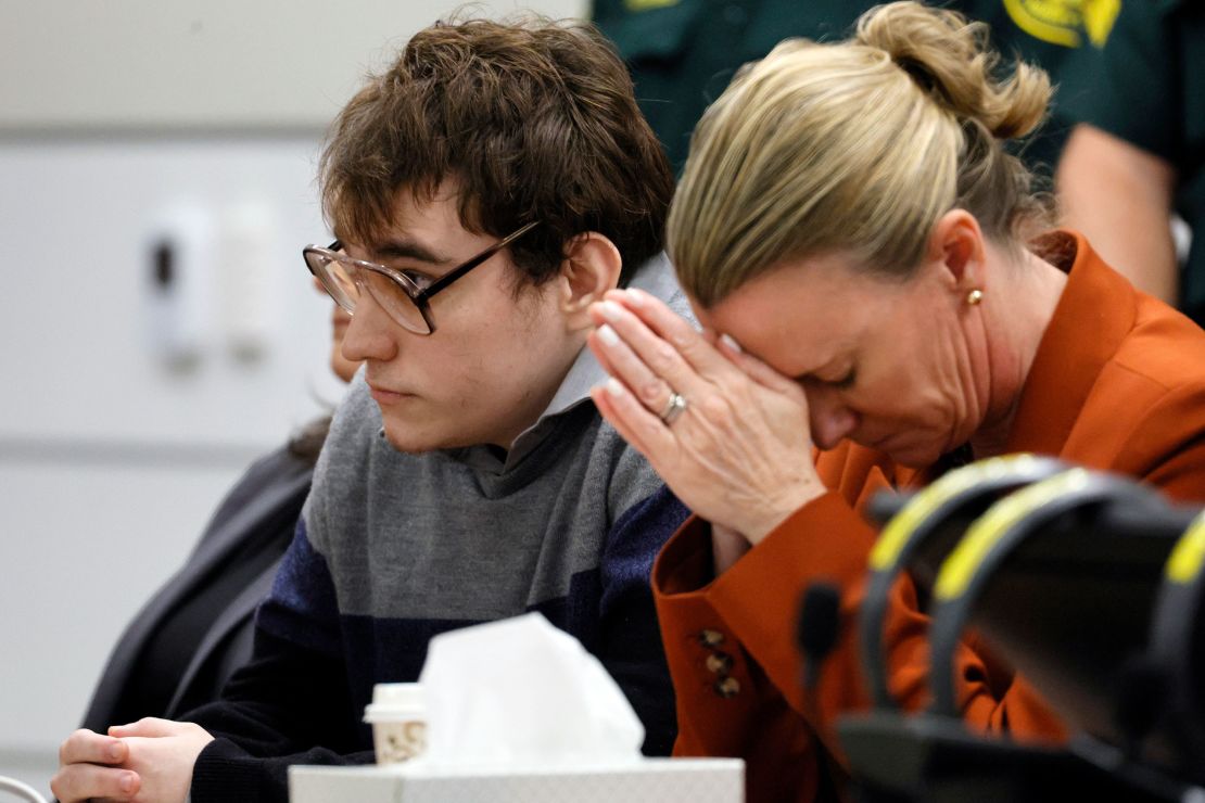 Assistant Public Defender Melisa McNeill touched her hands to her head while sitting next to Nikolas Cruz as the verdicts were read in court on Thursday.