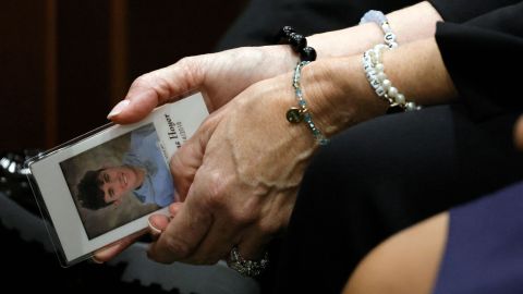 Gina Hoyer holds a photo of her son Luke, who was killed in the Parkland shooting, as she awaits judgment on Oct. 13 in the Fort Lauderdale, Florida shooting trial. .