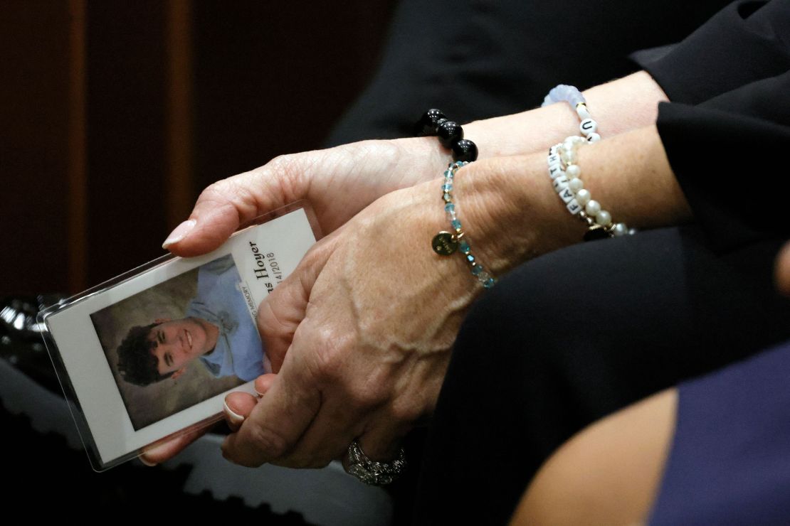 Gena Hoyer holds a photograph of her son, Luke, who was killed in the Parkland shooting, as she awaits the verdict October 13 in the gunman's trial in Fort Lauderdale, Florida.