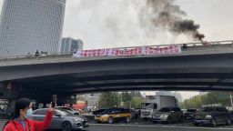 A banner is seen on Sitongbridge in Beijing October 13, 2022.