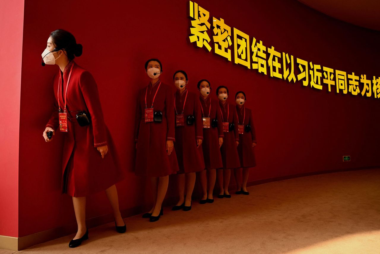 Attendants wait for people to visit an exhibition in Beijing on Wednesday, October 12. The exhibition, "Forging Ahead in the New Era," showcased China's achievements during Xi Jinping's two terms as general secretary of the country's ruling Communist Party. <a href="https://www.cnn.com/2022/10/11/china/china-party-congress-explainer-intl-hnk-mic" target="_blank">Xi is widely expected to seek an unprecedented third term</a> as China's top leader when the party meets for its National Congress that begins Sunday.
