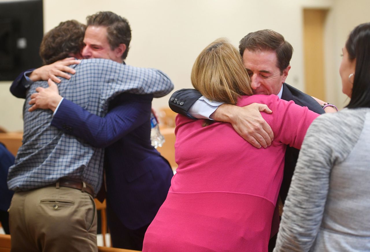 A couple of plaintiffs hug attorneys on Wednesday, October 12, after a Connecticut jury decided that far-right talk show host Alex Jones <a href=