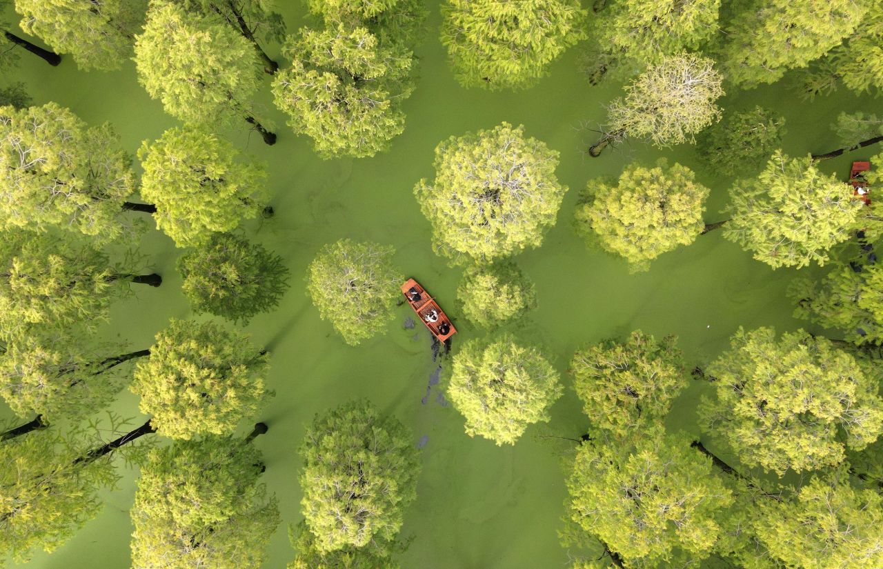 Tourists ride on a boat Friday, October 7, at the Luyang Lake wetland park in Yangzhou, China.